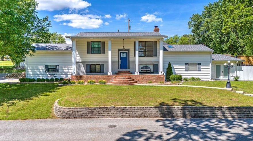 Sitting on almost 1 acre just minutes from Promenade Mall, Pinnacle Area Entertainment, and much more, this is a rare find in NWA. Bright and spacious split-level home with hardwood floors, new paint, and updates throughout. Living space is open to the dining and kitchen area, great for entertaining. Kitchen has granite, stainless appliances, gas cooktop and plenty of workspace. Large windows overlook the backyard and pool. Two guest bedrooms and fully remodeled guest bath on main level along with a bonus room. Lower level features a cozy second living room with fireplace. Updated flooring throughout lower level. The primary bedroom is a true retreat with large sitting area space and private backyard views. Primary bathroom has huge walk-in shower, great storage and vanity space. Home office space on lower level and access to the 2-car garage. This lower level could be a full owners retreat! Outside is your own oasis tucked away in town with a private in ground pool! Detached garage offers workshop/extra storage.