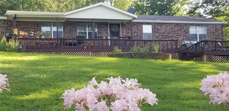 Beautifully updated, private, peaceful home on 4 acres. Great for home business, horses, gardening or city getaway. Home features huge sunroom, tongue-groove pine ceiling great room with large wall to wall brick wood burn fireplace, 2 living areas, 1 w/parquet wood, perfect for dancing! 4 beds or 3 beds/office. Fenced area w/arbor for entertaining. Formal dining & large laundry area. Newer roof, newer X-large 2 car garage. Well maintained home. Sunroom is 480 square feet.