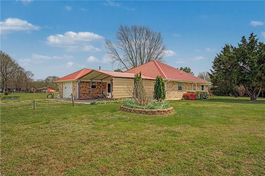 2 acres surround this well kept country home in Western Fayetteville.  Hard to find space like this with  new 35x18 Workshop and room for work equipment and/or recreational vehicles.  The all brick home features an amazing country kitchen full of light and space,  new backsplash and granite counters, wood flooring, fresh interior paint all gives a warm feeling. Also included is a garden shed for your lawn mower and tools. Natural gas from the city is available. Tankless water heater.  Sit back and relax on either of two spacious covered porches. Property has evergreen trees and three one year old fruit trees (apple, peach, and plum). Front porch fountain with live Cardinals included. Central vac system, a generator hookup, Metal roof added in 2017.  Perhaps the coolest feature -- An industrial strength Tornado/Hurricane shelter in place just in case the unthinkable happens. Schedule a showing soon and see for yourself.