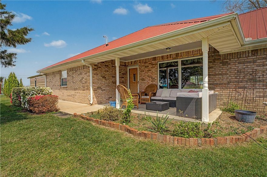 2 acres surround this well kept country home in Western Fayetteville.  Hard to find space like this with  new 35x18 Workshop and room for work equipment and/or recreational vehicles.  The all brick home features an amazing country kitchen full of light and space,  new backsplash and granite counters, wood flooring, fresh interior paint all gives a warm feeling. Also included is a garden shed for your lawn mower and tools. Natural gas from the city is available. Tankless water heater.  Sit back and relax on either of two spacious covered porches. Property has evergreen trees and three one year old fruit trees (apple, peach, and plum). Front porch fountain with live Cardinals included. Central vac system, a generator hookup, Metal roof added in 2017.  Perhaps the coolest feature -- An industrial strength Tornado/Hurricane shelter in place just in case the unthinkable happens. Schedule a showing soon and see for yourself.