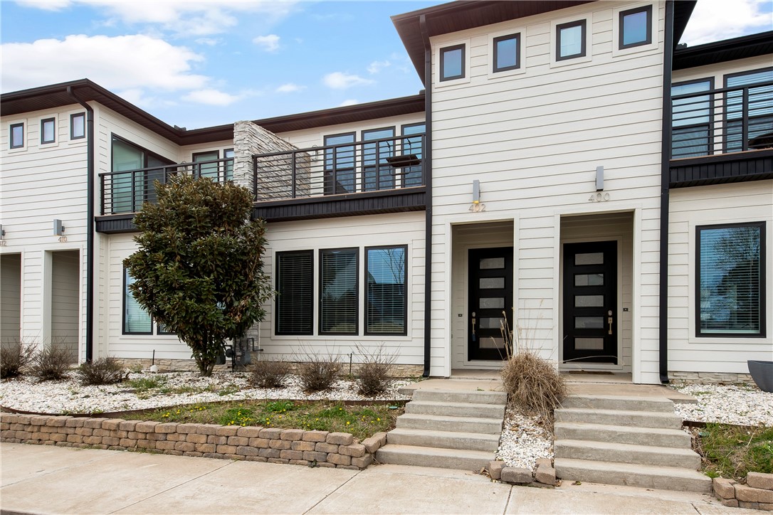 Enjoy your morning coffee from the second-level balcony of your new townhome as you gaze over the view of downtown. This wonderful townhome is in the heart of downtown Bentonville putting you close to all the action. It's located two blocks behind the Skylight Cinema. This 2 story designer townhome features a bright and open floor plan with high ceilings, beautiful lighting and upgraded appliances. The gourmet kitchen features a Thermador gas range perfect for whipping up an amazing frittata. There is a huge pantry and a separate mudroom area by the door to the garage. Upstairs you will just love the main suite with a huge walk-in closet, office nook and private balcony. There are two more bedrooms and a full bath on the second level plus a laundry room with a washer and dryer. The garage is a full 2 car garage with extra storage. This is one of 6 townhomes in THE DISTRICT.