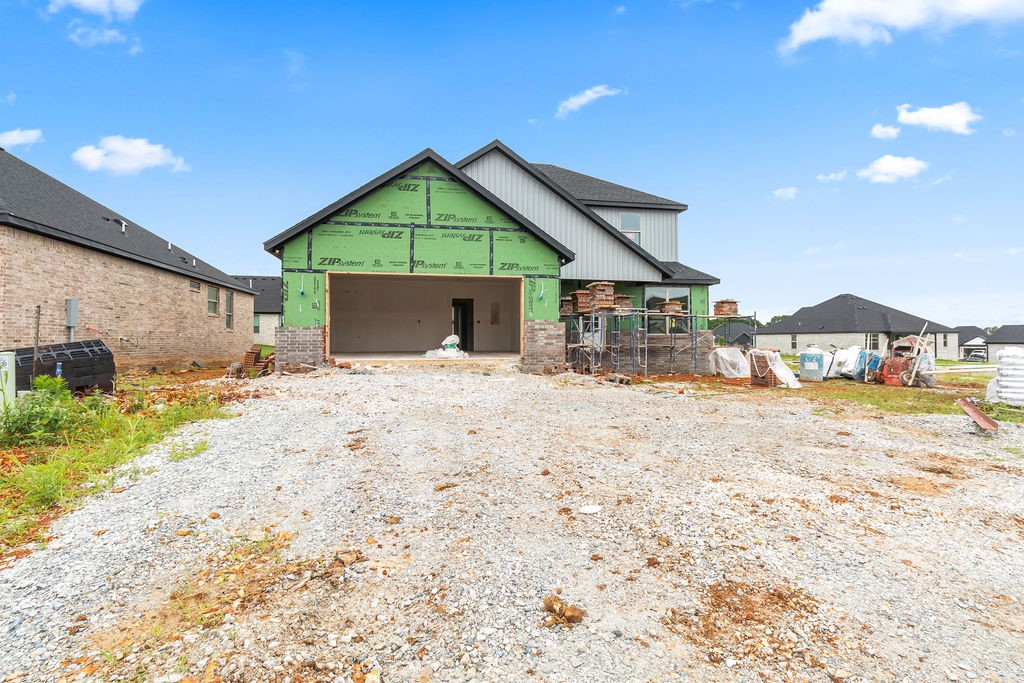 Welcome to Spring Creek Farms, located in the heart of Northwest Arkansas (Cave Springs/Elm Springs). There is something for everyone! A pool, playground & walking trails will be coming in phase 3. Shaw Elementary is just steps away. Enjoy pickleball, tennis, walking trails & more at nearby Shaw Park. This neighborhood has spacious lots with many backing up to green space. Call for more details & options available. The Rosemary Plan is a two-level, 5-bed (or 4 beds with an office), 2 1/2 bath layout designed with modern living in mind. Features include: open living floor plan, gas log fireplace, soft close custom cabinets to the ceiling, gas range with fully vented hood, built-in microwave, and covered back porch with TV and gas connections. The primary suite is on the main level and features a walk-in shower & a free-standing bathtub for the ultimate spa-like experience. Preferred lender credit available.