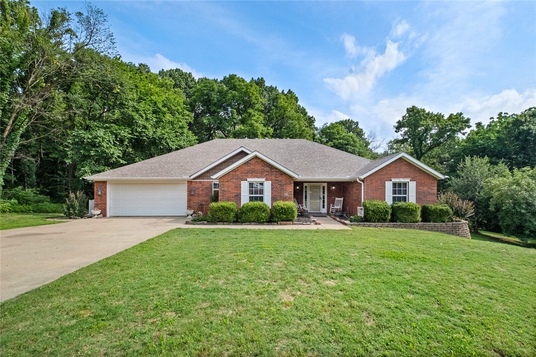 Beautifully maintained 3 bed, 2 bath home on 2 level cul-de-sac lots with space to live, work, and unwind. Includes office w/French doors, bonus guest room, and new LVP flooring in living & office. Recent updates include a new roof (2021), HVAC system (2024), gutter guards, and a stunning covered deck. Oversized 24x21 garage includes epoxy floors, HVAC vent, workbench, cabinets & utility sink. Additional gravel parking pad complements the main driveway. A separate powered workshop adds endless potential. Step out onto the gorgeous, covered deck—a true outdoor sanctuary with a tranquil wooded view. Stone pathway, raised beds, established grapevines, a producing apple tree, and a rain-fed irrigation system offer plenty of potential for outdoor enjoyment. Close to Loch Lomond, bike trails, golf & I-49 access.