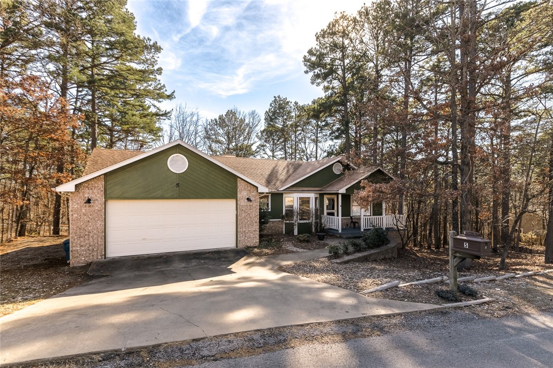 Nestled in Bella Vista, this charming home is a dream for outdoor enthusiasts and mountain bikers! Located just 0.5 miles from the Back 40 Trailhead and a short 0.5-mile walk to Lake Rayburn, it offers the perfect blend of adventure and tranquility. Plus, it's only a convenient 15 minute drive to everything Downtown Bentonville has to offer. Surrounded by empty lots on three sides, this home provides unmatched privacy and a serene retreat. The outdoor space is an entertainerās paradise, featuring three spacious decks that overlook a lush backyard filled with mature trees, along with a cozy fire pit perfect for crisp fall evenings.
Inside, you'll be greeted by natural light streaming through a large sunroom, hardwood floors, ceramic tile, updated lighting, and more! Bonus alert: there's a 300 sq. ft. finished bonus room, accessed from outside under the stairs, ideal for an office, game room, homeschool setup, or even a second living area.With character, charm, and unbeatable location, this is a must-see property!