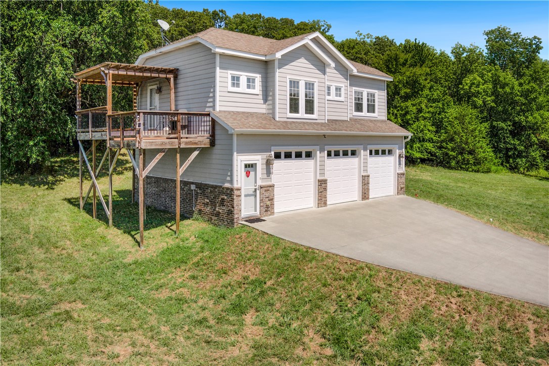 This well-constructed and meticulously cared-for home sits on prime East Fayetteville real estate. Think big, because this spot has room for dreams and growth. Tucked into a mountaintop, this 17.5-acre property provides a unique blend of privacy and convenience to Fayetteville and Northwest Arkansas. The gently rolling acreage has open and wooded areas with spring-fed ponds and a fabulous year around view towards the Boston Mountains.
The modern home, with its abundance of natural light and hardwood floors, features a spacious 3-car garage and a delightful deck that extends the living space outdoors. This location holds great potential, whether you're looking to nest, invest, or explore development opportunities. Come see what could be yours. It's not just real estate; it's a real opportunity!