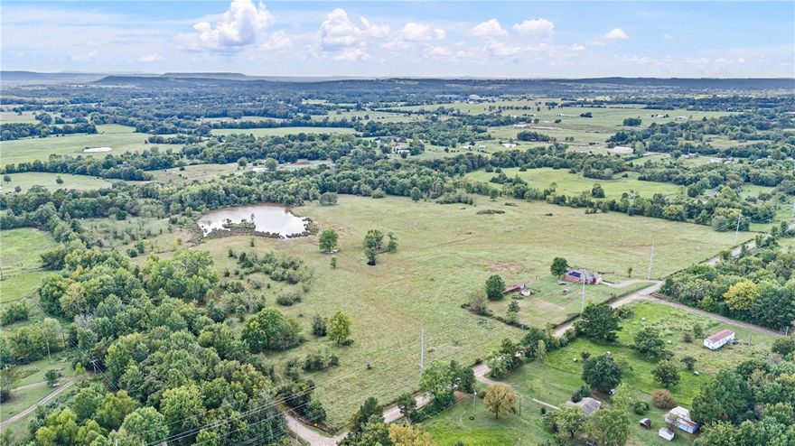 The beautiful flower gardens create a warm welcome as you arrive to the driveway.  Step into this charming all-brick home featuring 3 bedrooms, 2 full baths, and an open kitchen/dining area that overlooks 40+ fully fenced acres. Perfect for your own livestock or continue with the current land tenants for added income. Fenced in backyard for the kiddos and pets.
Enjoy lower utility bills with solar panels.  A large pond stocked with fish sets the scene for family fishing days and peaceful country living. With approximately 1700 sq. ft. of living space, this property combines comfort, functionality, and the beauty of wide-open land.