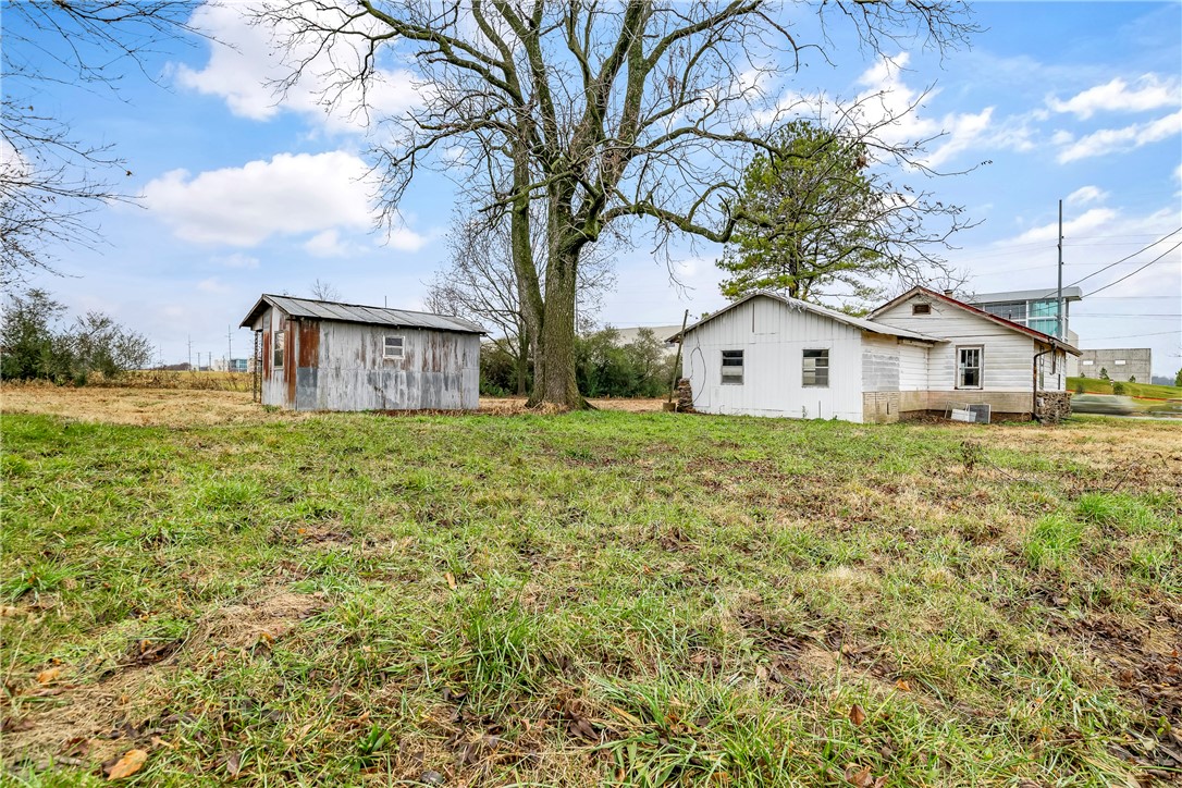 This property stands out for its flexibilityāwhether you're thinking commercial, residential, business in the front & residential in the back, or multifamily, the options are wide open in a high-growth corridor Just minutes from XNA Airport, the Walmart Distribution Center, and Downtown Bentonville, it's ideally situated in a fast-growing area surrounded by neighborhoods, apartments, and warehouses. Zoned agriculture; all development plans and sewer tap access must be confirmed with the city. This is a rare chance to shape a space that fits your vision. House has NO Value, Not Livable, property is sold as-is. Preliminary design layouts for the property are attached.