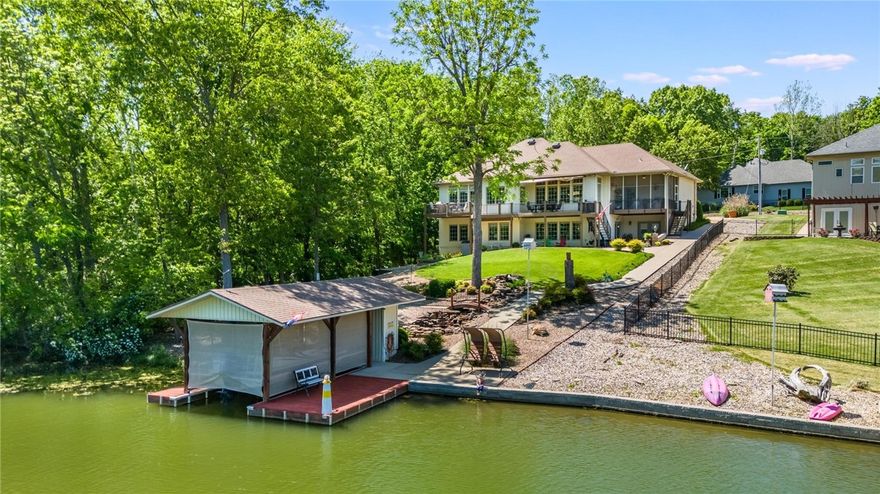 Experience lakeside luxury in this stunning 5-bedroom, 3.5-bath home with an office on scenic Loch Lomond. The oversized Master Suite boasts breathtaking lake views, a spa-like bath with double vanity, makeup area, steam shower, and air jetted tub. Enjoy serene water access with a gentle slope leading to your private dock with boat lift. The living room features hardwood floors, 10' ceilings, and floor-to-ceiling windows framing panoramic lake views. Entertain in the screened porch, around the firepit, or in the dedicated home theater. The updated kitchen includes an induction cooktop and modern finishes. An oversized 3-car garage offers ample storage. There are too many features and not enough characters to describe this home. Please check out the features attachment. This home blends elegance, comfort, and lakefront living. Welcome Home!