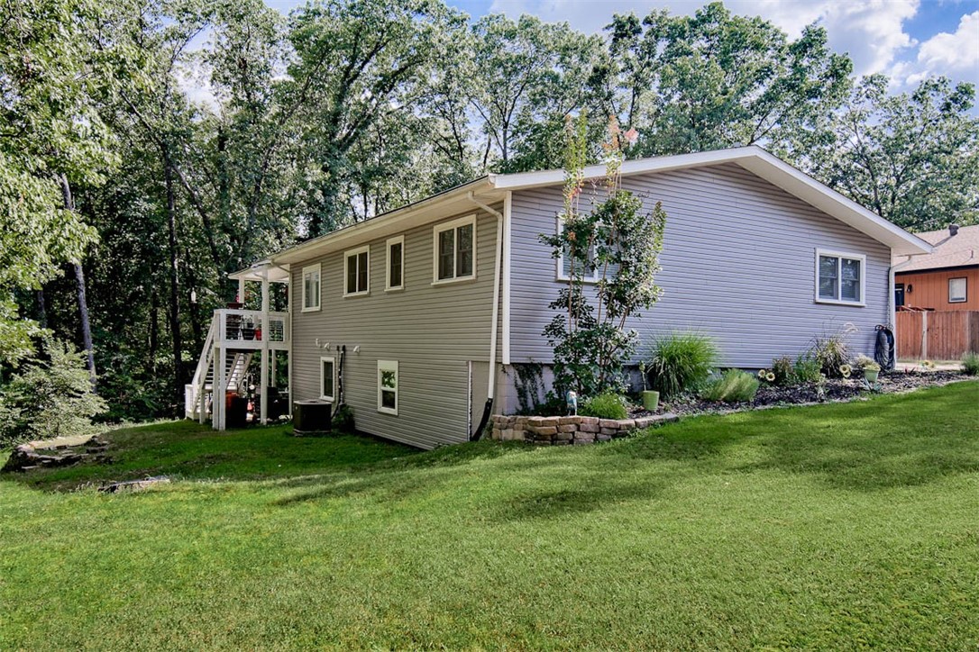 This beautifully renovated home is a dream for anyone who loves modern living & the outdoors. The main floor has an open layout w/stunning kitchen, stainless appliances, huge pantry & granite. The living room is a cozy & stylish space w/electric fireplace, custom wood beam & luxury vinyl plank flooring. Large windows let in plenty of natural light & the sunroom and deck offer peaceful views of the surrounding woods. The main bedroom is the perfect retreat w/updated bath & huge walk-in closet. The walkout basement has its own entrance, making it perfect for an in-law suite, or extra living space. You'll also find a flexible room ideal for an office/gym. The outdoor area is a private oasis w/covered deck upstairs & private patio downstairs, a firepit and a greenhouse for gardening. Lake Avalon beach area is just down the road & Lago Vista bike trail is right outside the back door. You will have easy access to all the outdoor activities that BV provides. The home also features garage with a workshop & large driveway.