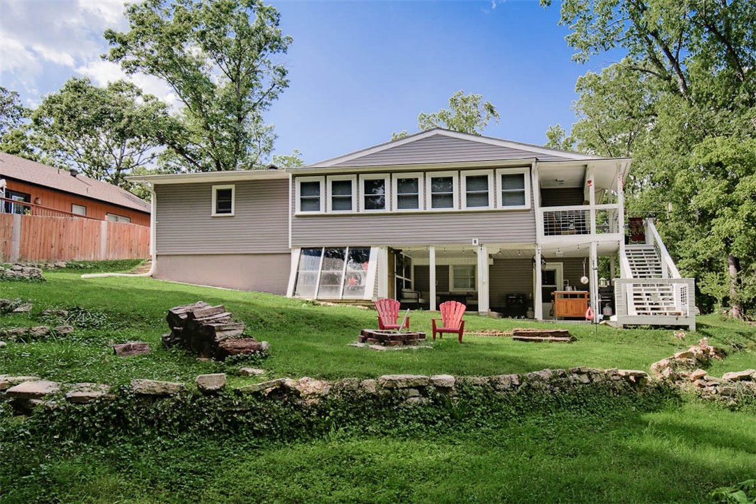 This beautifully renovated home is a dream for anyone who loves modern living & the outdoors. The main floor has an open layout w/stunning kitchen, stainless appliances, huge pantry & granite. The living room is a cozy & stylish space w/electric fireplace, custom wood beam & luxury vinyl plank flooring. Large windows let in plenty of natural light & the sunroom and deck offer peaceful views of the surrounding woods. The main bedroom is the perfect retreat w/updated bath & huge walk-in closet. The walkout basement has its own entrance, making it perfect for an in-law suite, or extra living space. You'll also find a flexible room ideal for an office/gym. The outdoor area is a private oasis w/covered deck upstairs & private patio downstairs, a firepit and a greenhouse for gardening. Lake Avalon beach area is just down the road & Lago Vista bike trail is right outside the back door. You will have easy access to all the outdoor activities that BV provides. The home also features garage with a workshop & large driveway.