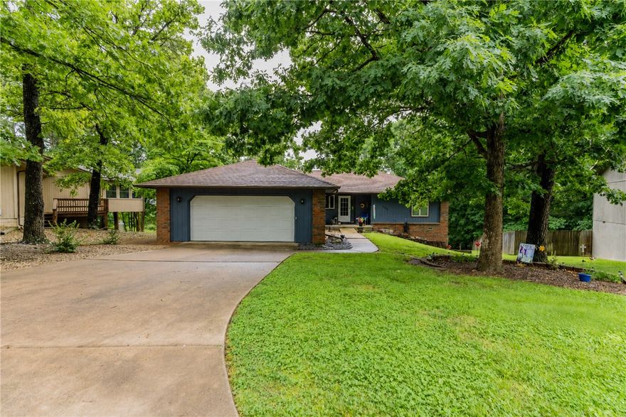 Fantastic 3 bed, 2 bath home + all season room near Lake Windsor in Bella Vista. Bentonville school zone! Enjoy gatherings on your large deck space overlooking the large yard with tons of trees surrounding you on a nice quiet area. Split floor plan with large primary suite. Kitchen is partially open to the large living room with fireplace. If you're seeking a peaceful place to live, this is the one!