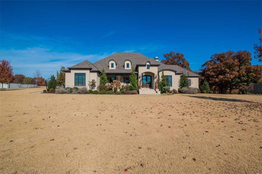 Distinguished custom on 1.5 acres in desirable Estates of Dogwood Canyon.  Designed for entertaining. Stunning kitchen w/ granite, center island & wet bar open to living and dining areas. Complete w/ wall windows & wood beams. 5 BRs, 4.5 baths offers master retreat, study & 2 ensuites on main level. Add’l 2 BRs & den upstairs. Covered veranda w/ fireplace & patio offers scenic views of the lot. Ample closet and garage space for storage.  6 inch walls with low utility costs.