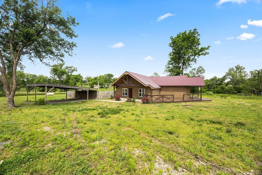 Surveyed 1.7 acres with cabin vibes. Open kitchen to living. 3cm granite counters, stainless steel appliances including double ovens and six burner propane range. Wet bar with ice maker and wine cooler. Lots of cabinet space, pantry, dedicated laundry room. Big closets. Wrap around deck with two covered spaces. Hard surfaced floors throughout.  Less than 10 miles down Hwy 102 from Walton Blvd. (Copy of recent survey available in attachments - Parent Tract 1)