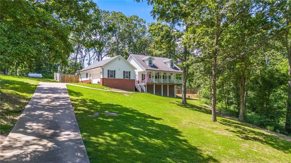 Welcome to 4200 Hilltop Dr in Little Flock, AR. This beautiful 3-bed, 2-bath, brick home sits on top of a secluded 1.23 acres with a private in-ground pool. Location is great for those looking to be close to Bentonville, Rogers & Pea Ridge while having space and privacy. Relax and enjoy the tranquil views from the east facing oversized covered front porch which provides afternoon shade. Soak up the sun relaxing around the pool in the backyard with plenty of room for entertaining. The kitchen is at the heart of the house & features granite counters, stainless appliances & a 5-burner gas stovetop. The spacious primary suite provides access to the back deck. The large bonus room upstairs can be dual purposed & is perfect for a home office, family room or guest space. Living room features a cozy pellet stove & access to the back deck. Kitchen equipped with newer appliances & a new tankless water heater was recently added. Just 4 miles to Downtown Rogers, 5 miles to the new Walmart Campus & 6 miles to Pea Ridge.