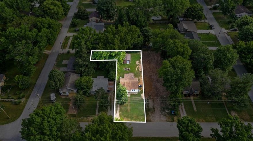 Downtown Bentonville Location only a few blocks from Crystal Bridges, and the bike trails. This property has a public alley behind it that can be opened up for rear parking or a future home with rear access. 
Terrific investment property in the hub of Downtown Bentonville, would make an incredible AirBNB. Good sized L Shaped lot with Public access alley to the rear of the parcel. The homes on both corners of this street are  renovated and the lot next door to the east has been cleared for a new construction home.  Real Wood floors, New HVAC 2020, good size storage shed. Also listed as RES MLS #1236644