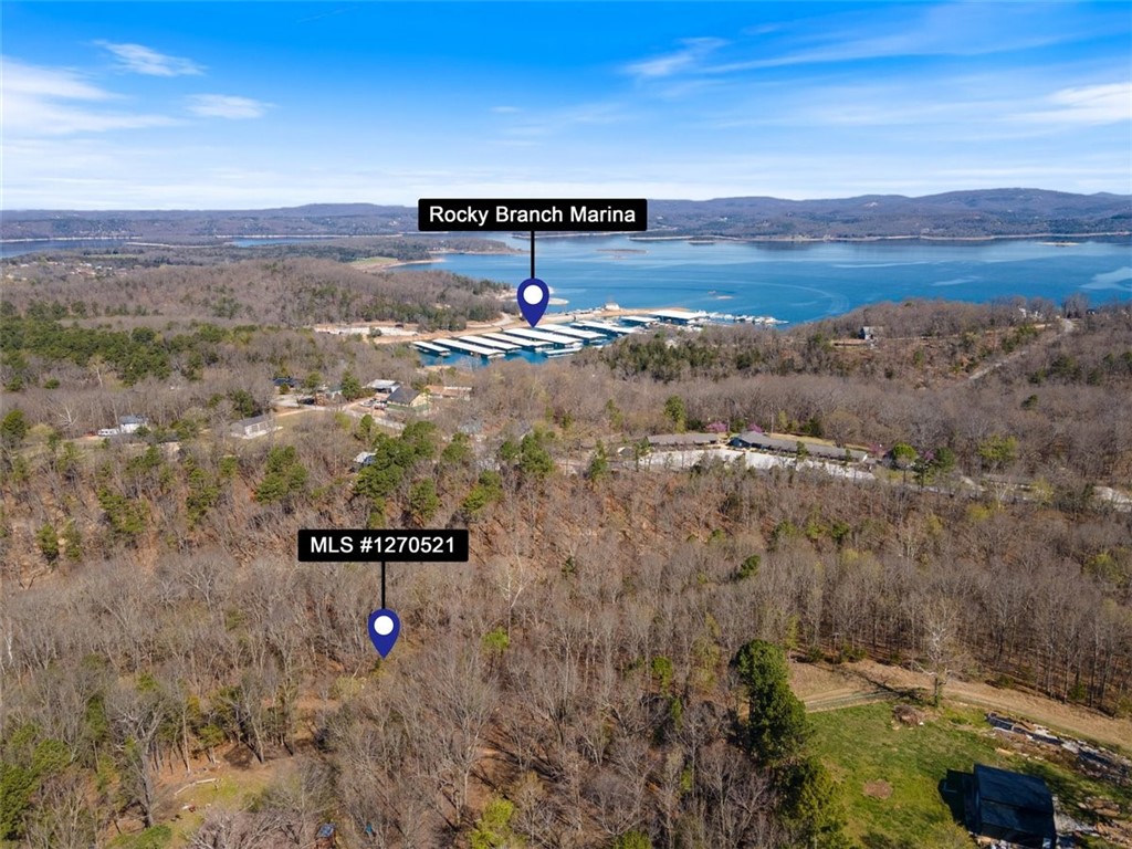 Uncover the beauty of lake living with this stunning 1.68-acre parcel near the breathtaking Beaver Lake. Situated close to the renowned Rocky Branch Marina & Campground, this property spans three lots, offering endless possibilities for your dream lake area home or a sprawling retreat across all three lots. Embrace the natural splendor of sloping, wooded terrain, perfect for creating your private sanctuary. Enjoy easy access to hiking and biking trails, along with the nearby Hobbs State Park. Nestled outside city limits, yet just a short 15-minute drive from the vibrant hub of Downtown Rogers, seize this opportunity to craft your ideal lakeside lifestyle in picturesque Northwest Arkansas!
