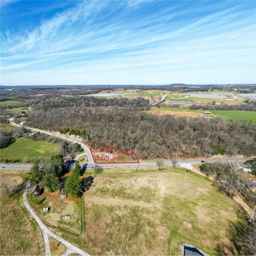 Exceptional opportunity with this 0.69-acre corner parcel at the intersection of Hwy 45 and Hwy 303. Located on the east side of Goshen with a Fayetteville address, this property offers unbeatable accessibility — just minutes to Hwy 412 for quick routes to Springdale or Rogers, and direct access along Hwy 45 to Fayetteville or Huntsville. located outside city limits, the lot provides added flexibility for future development. High visibility, strong traffic flow, and the strategic corner placement make this an ideal location for a variety of uses, including potential commercial ventures. Whether you're looking to build, invest, or grow your business footprint in Northwest Arkansas, this property offers the space, placement, and convenience to make it happen.