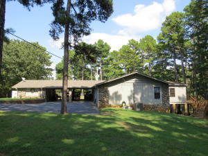 Privacy,Peace,& Pleasure is what you will find when you step on this property. 14.4 acres that are shaded w/tall trees you can enjoy long walks or take the kids fishing on the 2 stocked ponds w/all kinds of fish. Inside you'll find 2 large living rooms & a split floor plan for your convenience. Let's not forget about huge shop for all your hobby needs. Come see what peace & quiet truly looks like!