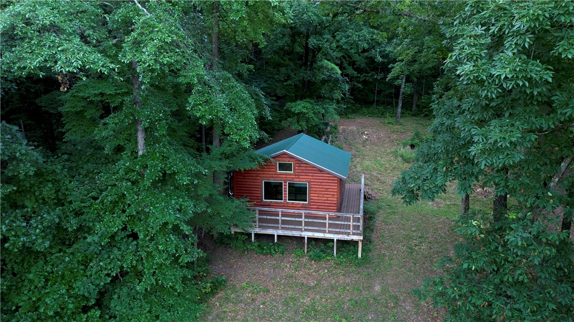 This stellar 120 +/- acre property checks all the right boxes. Build your dream home, create a hunting retreat, or enjoy it as a weekend getaway. With plenty of road frontage, maybe even some investment potential?. Itās private, well-set up, and full of Ozark charm. The western entrance leads to a 30āx30ā two-bay shop with electric, rural water, and fiber internet. Electric runs the full length of the property. On the "back 60", a rustic off-grid cabin sits perfectly for big northern views. The cabin intentionally has no utilities, but electric is close. The terrain includes drainages flowing to Dabney Creek, natural pools, seasonal waterfalls, a small pond, and a solid trail system. Deer, turkey, and bear sign are everywhere with great hunting terrain features which include benches, funnels, and edge. A 3 +/- acre clearing in the āback 60ā offers good habitat and a hunting blind. Mostly white and red oak, plus sugar maple. Gated access off a private road and Madison 5540. Just 30 min to Elkins, 40 to Fayetteville!