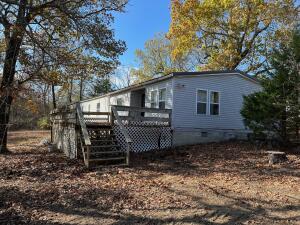 Elbow grease will go a long way. This 3 BR 2 BA Doublewide manufactured home sits on 13 acres and is not too far out, just far enough to give you some privacy. The mobile does need some work and the property is selling ''AS-IS.'' There is a great 30 x 60 shop on the property that would be a great hobby shop or you could use it to store that boat! The shop is wired for 220.