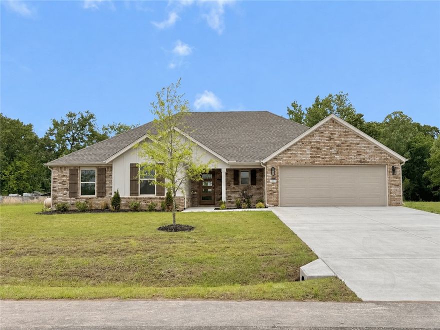Situated on a spacious 3/4-acre lot in Saddle Hill Estates in Rogers, this sought-after Kennedy Plan offers 4 bedrooms, 3 full bathrooms, and 1,989 square feet of thoughtfully designed living space blending comfort, style, and functionality. Inside, you’ll find upscale finishes, custom cabinetry, abundant natural light, and an open-concept layout perfect for everyday living and entertaining. The spacious kitchen features a large pantry and flows seamlessly into the dining and living areas, highlighted by a cozy gas fireplace. The private primary suite offers a relaxing retreat with a soaking tub, separate shower, and generous layout, while a second ensuite bedroom is ideal for guests or multigenerational living. Outside, enjoy the oversized covered patio and expansive lot with plenty of room for entertaining, recreation, or peaceful outdoor living. This home perfectly combines elegant design, practical living, and exceptional outdoor space. *Please note gas logs are not provided for liability reasons.