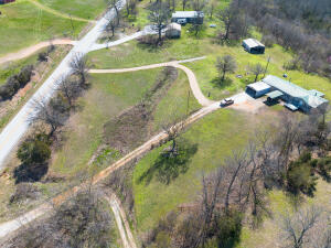 Only 2 miles from Lead hill and Bull Shoals Lake. Great country living with quick and easy access to Highway 14. Beautiful yard with plenty of room for garden, fruit trees or anything else your heart desires. Screened in Porch on the back to enjoy quiet time and plenty of room to roam with nearly 9 acres. Great bonus room or Man Cave with a ready made bar for entertaining. Man cave has separate Heating and cooling from main house. Wood Burning Fireplace! Lots of Storage, workshop area in the rear of the house and an additional outbuilding for storage/workshop space.
