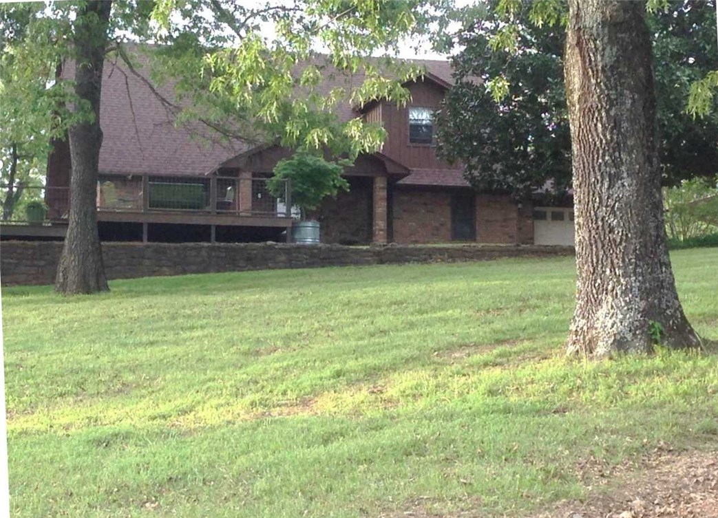 Serenity at it's finest, with views of Lee Creek and mountains of Oklahoma! 2600 sq ft of cypress deck, garden, pasture fenced and cross fenced, city water, well water & spring fed pond. Shop is 30 x 50 with full bath, bachelor pad, water & own septic. Fruit trees, chicken coop & 3000 gal rain water collection system for all outdoor watering. House features 3 BR, 2 BA, 2 story with overlook into den. Lots of amenities! All & more on 40 acres! A must see!