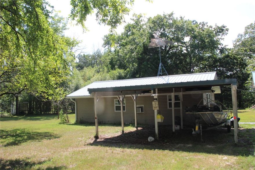 Location, location, location!!  Cross the highway and you will find the entrance to the Hwy 125 campground and Marina.  Enjoy the beautiful Bull Shoals Lake at your leisure.  This 3-bedroom, 1 bath home offers hardwood floors, screen porch, open eat in kitchen, and a separate cabin for guests or use as a rental.  The cabin includes, living room, eat in kitchen, 1 bedroom and 1 bathroom.  The 1-acre lot is bordered on 2 sides by the Corp of engineers.