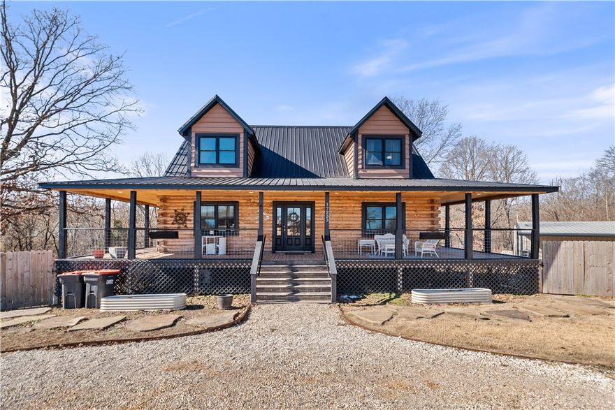 Welcome to your dream country retreat just a few miles north of Pea Ridge, Arkansas. This custom-built home offers a unique blend of rustic charm, modern comfort, and versatile living space. Set on 2.5 private, wooded acres, the property showcases a spacious 3,258 sq ft residence with five bedrooms and three full bathrooms — ideal for families, multi-generational living, or guest accommodations. A wrap-around covered porch, offering scenic views of the yard, above-ground pool, and surrounding countryside — perfect for entertaining or quiet relaxation. Adding to the appeal is a insulated shop building with an 800 sq ft apartment, also used successfully as an Airbnb or rental. The shop includes multiple large overhead doors plus a 20’x60’ covered concrete recreation area that can be enjoyed as a private pickleball and volleyball court. The perfect mix of space, privacy, recreation and relaxing country style feeling. Just 20 minutes away from downtown Bentonville and Walmart HQ.