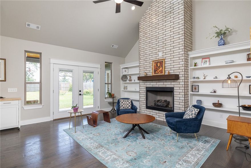 This is exactly the type of space you've imagined for yourself, a perfect balance of modern finishes and classic styles, high ceilings and natural light, all within walking distance to DT Rogers, bike paths and more. Picture yourself welcoming guests to your friendly porch or enjoying a relaxing evening on your covered patio(w/woodburning fp!) or any of the stylish rooms inside the home as well. The open floor plan showcases a view of the stylish architectural lines and the plethora of cabinets, granite counters, SS appliances and a fantastic pantry, plus the modern brick fireplace, built-in shelving and hardwood flooring throughout the entire main level to include the main bedroom suite and home office. That main suite offers access to the covered patio, and a gorgeous bath with fully tiled shower, beautiful finishes and a spacious closet. Upstairs, you'll find 3 spacious bedrooms (one of which is perfect as media room) and another full bath. Don't miss this chance, you'll want to come see this home right away!