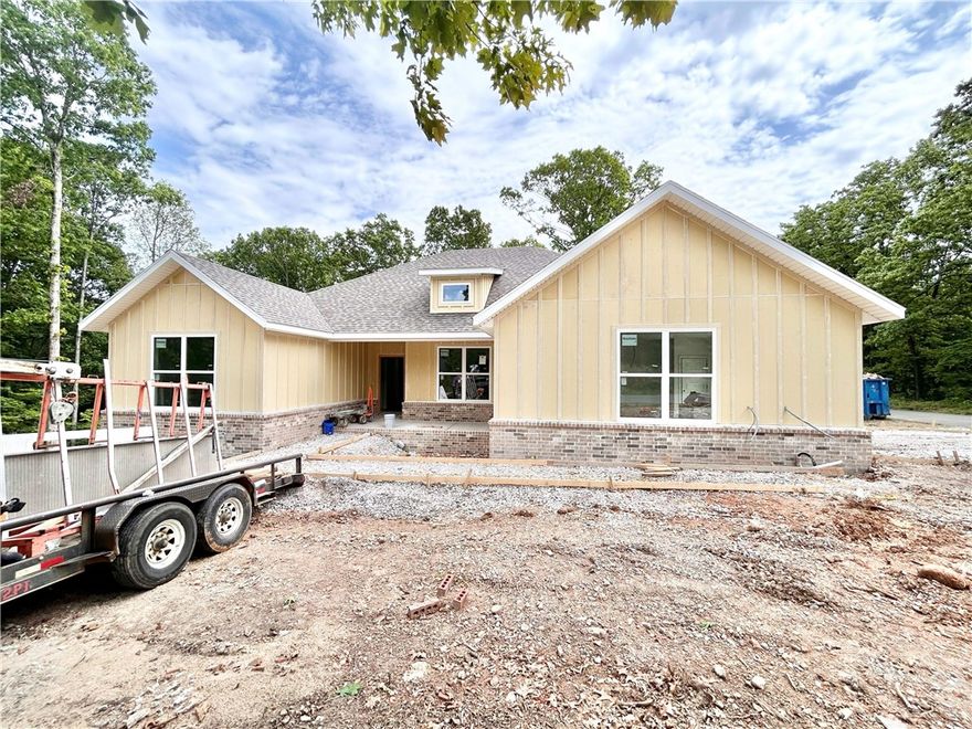 Stunning new construction home on a .69 acre double wooded lot with flat backyard located right next to Branchwood Recreation Center and Trails! Also within close proximity to Highlands Golf Course, Lake Loch Lomond, and I-49! Step inside to discover a beautifully designed interior with 4 bedrooms, a split floor plan, & high-end modern finishes throughout. 2 car side load garage! The spacious living area showcases vaulted ceilings with elegant beams, creating an inviting atmosphere. The kitchen features sleek 3 cm quartz countertops, a gas range, custom cabinets, and stainless-steel appliances. Retreat to the luxurious primary bath, which boasts a huge walk-in closet, a large custom walk-in tile shower, and a soaking tub. 2 covered patios. As an added bonus, receive $3,500 towards buyer's closing costs when working with the builder’s preferred local lender! "Front exterior will be painted Sherwin-Williams Evergreen Fog"