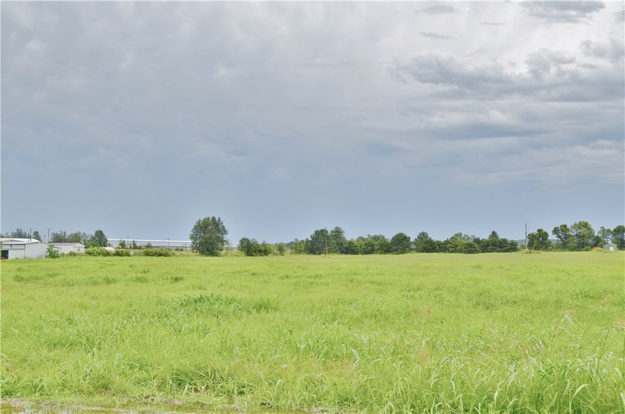 19.26 ac m/l of level beautiful land waiting to be developed in a great location that is growing. Razorback Greenway Trails across the street, close to I-49, shopping and restaurants.