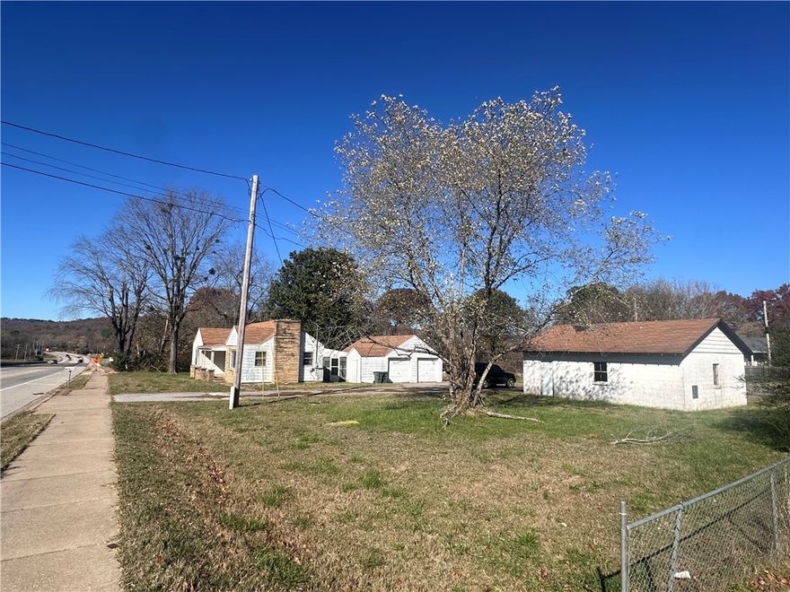 This 0.975-acre lot, located just 10 minutes from the University of Arkansas and 8 minutes from Downtown Fayetteville, sits in one of the fastest-growing areas of the city. With RMF-24 (Residential Multifamily) zoning, allowing up to 24 units per acre, and significant highway frontage, this property offers outstanding development potential. It is ideal for a multifamily or townhome project, taking advantage of the high demand for housing in this vibrant area. Additionally, the property features an older home and a detached garage, both of which could be renovated to provide immediate rental income while the development is underway. The property is situated in a rapidly evolving area with proximity to major highways, commercial centers, schools, and parks, making it a highly attractive option for future tenants. With its prime location, zoning flexibility, and strong growth potential, this property is a rare find for developers and investors alike.