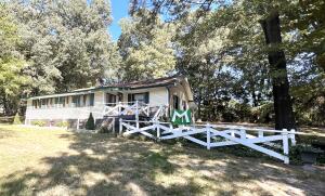 Beautiful country setting just 10 minutes from town. Sit on the back covered porch and have your morning coffee while relaxing to the sound of the rooster crowing. This 2 bedroom 1 1/2 bath home is perfect if you want to get away from the noise. The property sits on 1.83 parklike acres with a 36x30 shop. Don't miss this amazing property.
