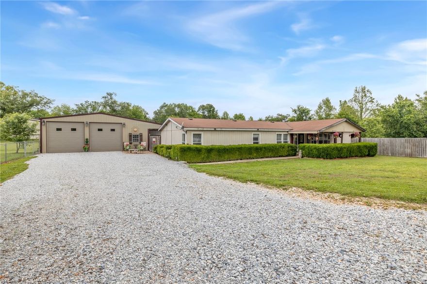 Charming 4 BR/2.5 BA on 1.37 Acres w/Shop, Garage & Pool - Near Springdale. Enjoy privacy & convenience just 1/8 mile off Hwy 412 on a quiet dead-end road. This updated home features a spacious primary suite, eat-in kitchen, formal dining and upgrades throughout. Entertain outdoors on the large deck with pool, stone fireplace and pergola. BONUS STRUCTURES: 40X40 Shop w/ 3 large garage doors, plus living quarters (1BR/.5BA, living room, kitchenette, wall unit). 28X30 GARAGE w/ 2 garage doors, storage, climate-controlled(mini-split) office with loft. Plenty of room to live, work and play all minutes from Springdale and lake access!
