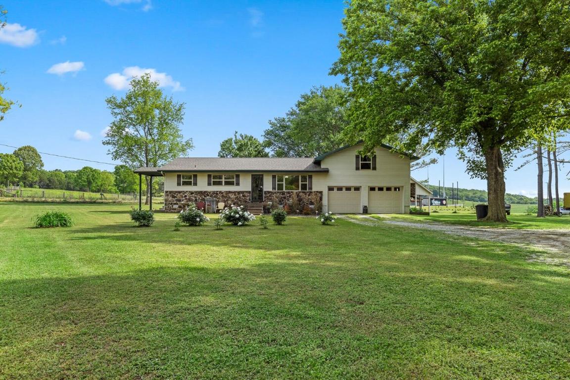 Charming country-style residence with 1,810 sq ft, 3 beds, 2 full baths, and a bonus loft above the garage with separate entrance on 14.4 acres of level, versatile land--half pasture, half wooded. Features a 2-car garage, a spacious covered back porch, 3 ample garden areas, and meticulous landscaping. This must see is a well-maintained home, shed, and a 60x90 shop with electricity and RV parking. Secluded at the end of a dirt driveway, offering endless possibilities with no restrictions!