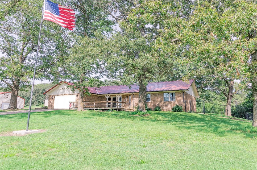 Welcome to your dream homestead! This well-maintained farmhouse sits on 10 acres, perfectly positioned right off Hwy 412 – offering the best of both worlds: peaceful country living with quick, easy access to town. The home features granite countertops in a inviting kitchen that opens into comfortable living spaces full of natural light. Outside, the property is thoughtfully designed for functionality and rural living. Multiple outbuildings provide ample space for storage, workshops, or livestock use. 40x80 Steel barn, 24x70 Implement shed, 24x30 carport, 30x40 shop building with electric. Working pens are already in place, making this an ideal setup for farming. Several well-placed water hydrants across the property ensure easy access to water wherever you need it. The entire property is fully fenced, including a separate dog-friendly fenced area to keep your pets safe. And with no dirt road access, you’ll enjoy the privacy of the country without sacrificing smooth travel. Please see attached doc for updates.