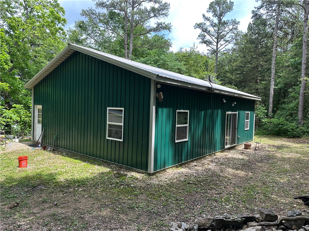 Two Homes, 2 outbuildings on 4.2 private wooded acres in the country on dirt road. Older frame home needs renovation and Barniminium needs completion. Seller has health issues and unable to maintain the property. This would be a good investment for someone who wants a fixer upper and has construction skills. Road will not accommodate a typical street vehicle, 4x4 preferred, but not necessary, just needs to be higher off ground than normal street vehicle. This property will require a buyer unafraid of physical labor. This place could easily be the affordable mini farm you always wanted or a place for multiple family residence. Not far from Table Rock lake at Beaver Town for fishing, boating or swimming if you like cool water. Barniminum has hot water radiant heated floors plumbed, but needs the mechanicals to work. Has high ceilings. 1200 sfin Barniminum built in 2019 and 992 sf in older 2 story frame house built in 1980. Has several outbuildings. One is a chicken coop. Play fort/treehouse workbench in barn