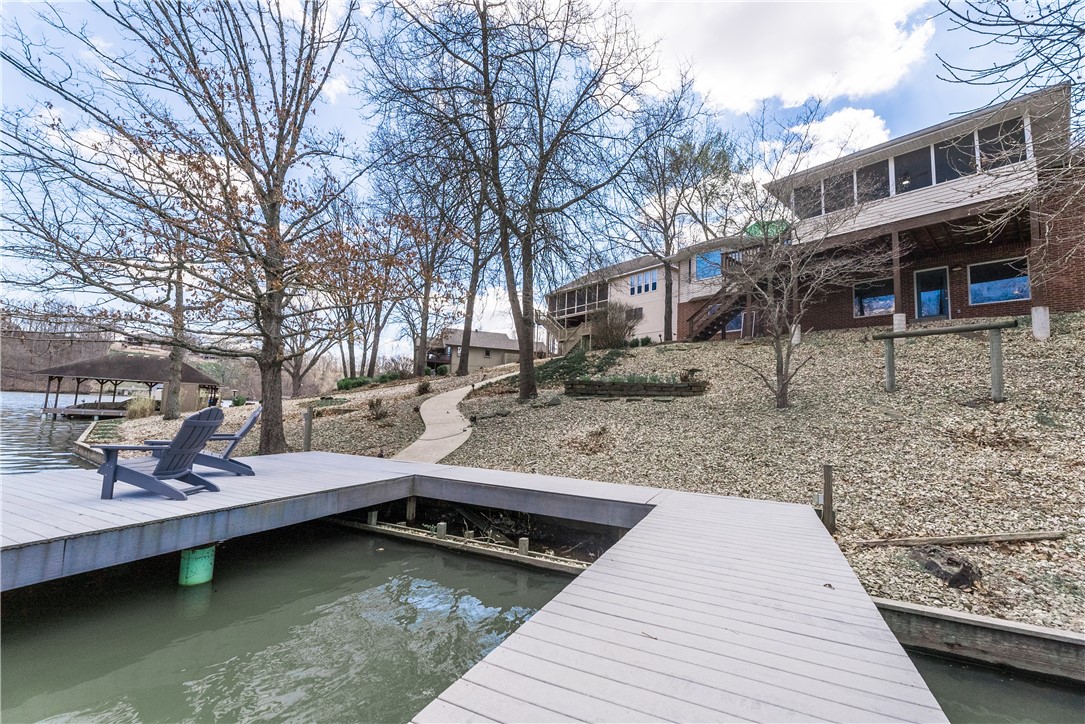 Discover Lakeside Bliss at 38 Rannoch Dr, Bella Vista, AR
Nestled on the shores of picturesque Loch Lomond, this stunning lake house offers the perfect blend of tranquility and adventure. With direct lake access, this property is a dream come true for water enthusiasts and nature lovers alike.The interior of this lake house is designed to maximize comfort and capitalize on the stunning views:
Open-concept living area with large windows framing the lake
Fully equipped kitchen perfect for preparing lakeside meals
Cozy bedrooms offering peaceful retreats after a day on the water
Spacious deck ideal for outdoor entertaining and soaking in the scenery