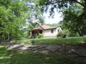 Many updates on this older 3 bedroom, 2 b ath home on 23 acres. Year round creek through property. Excellent pasture. Woods. Huge hay barn. Shop building. Garage.