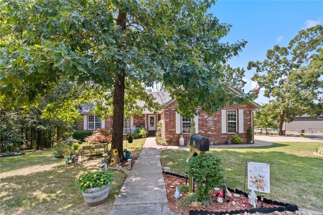 Beautiful and well loved home, nestled in Bella Vista Highlands on a quiet, dead end street, with two additional lots totaling 1.03 acres (3 lots). Imagine evenings gathered around a built-in stone fire pit or sitting on your screened in back deck, surrounded by mature trees, creating a serene and private atmosphere. Quick access to the Bella Vista Bypass, Branchwood Rec Center & Nature Trail, Loch Lomond, and in between Highlands and Scottsdale Golf Courses makes for easy commutes for activities. Underneath the home you will find a golf cart garage (or project space) that is heated & cooled with a storm shelter. (Accessible from the inside.) Well maintained lawn and garden space filled with perennials. Inside the home, generous windows invite ample natural light. Primary bedroom features two walk in closets. Kitchen is updated with granite countertops and glass back splash while the peninsula offers extra bar top seating. New roof in 2021. Discover a property withĀ boundless opportunitiesĀ for personalized touches!