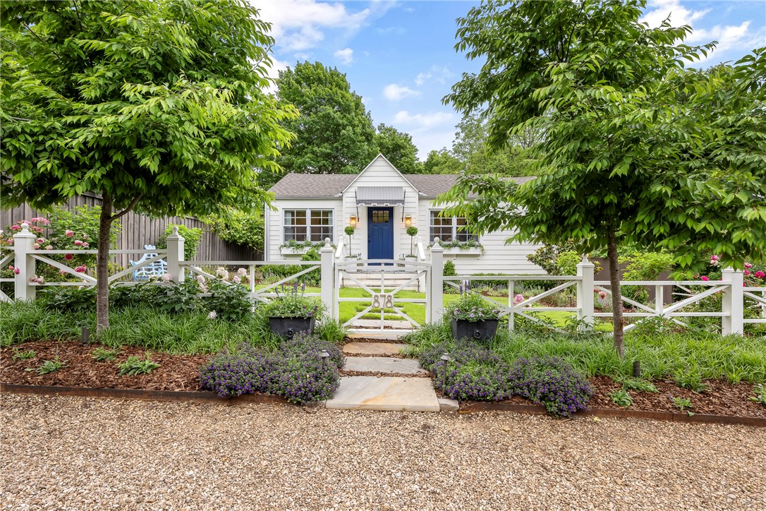 Charming, fully renovated cottage (2020–2022) in Fayetteville’s historic district, designed by award-winning Daniel Keeley of DK Design. Interior highlights: natural light, painted hardwood floors, custom kitchen and bath, designer fixtures, linen curtains, ample storage, and new HVAC (2021). Exterior updates: new roof, Hardie Board siding, windows, and doors. Professionally landscaped front yard features off-street parking, fenced entry, blue stone walkway and porch, custom railing, irrigation system, and landscape lighting. Spacious new deck spans the rear, perfect for outdoor living. Backyard includes gravel courtyard, fire pit, bistro lighting, and large lawn. Detached, grandfathered 1-car garage has new roof, floor, lighting, auto door, and 220V EV charger. Second EV outlet in driveway. Walk to downtown, Fayetteville Square, U of A, and Root Elementary. Quiet, friendly, walkable neighborhood—ideal for families, professionals, or students.