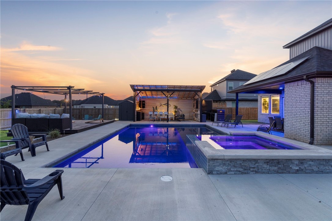 At home in northwest Arkansas, located in beautiful Bequette Farms neighborhood in Centerton offering a special place to make memories with a luxurious, resort-style outdoor living space like no other. This carefully designed home is completely solar powered with an 11.75 kw system covering all electric costs annually controlled with an app. Enjoy a heated, chlorine automated (6'5" depth) pool, with lounge ledge and separate covered living area, as well as covered dining space with an outdoor fireplace. An additional fire pit fits perfectly into the landscape as part of this incredible outdoor experience. With classic and timeless curb appeal and elegant interior finishes, this property is unmatched with its customized amenities for the ultimate place to gather and entertain. Just minutes from downtown Bentonville, it provides easy access to bike trails, shopping, dining, and top-rated schools. This exceptional home is simply a must-see! Both pool and solar installed in 2023. Closing to be after October 5th 2024