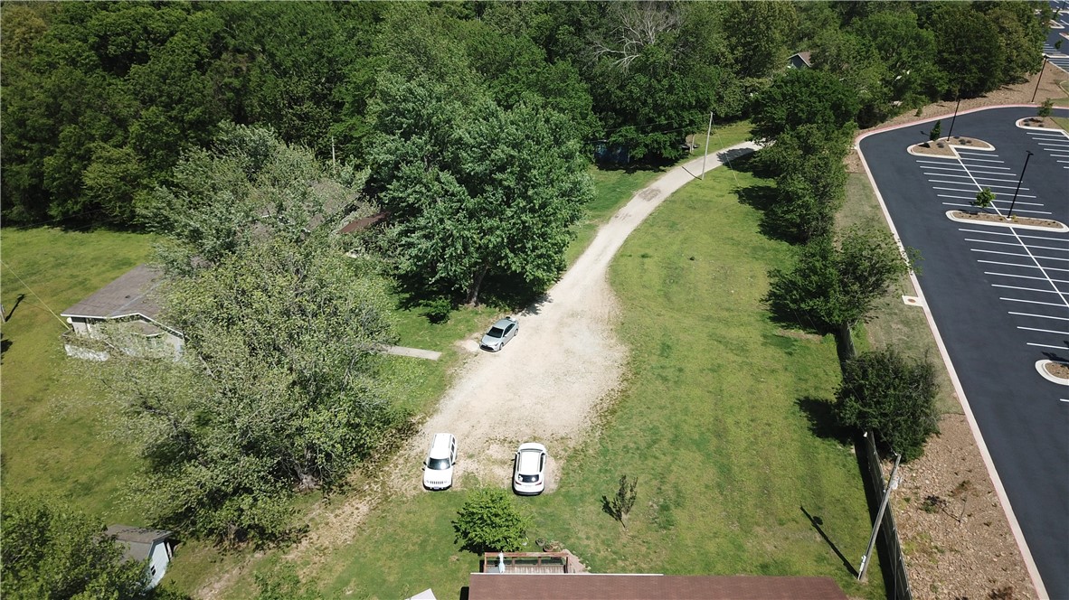 Be a part of the continual growth of Bentonville! This listing includes approx 5.2 acres (5 parcels) & 3 homes (5,871 approx sq ft total) but possibilities abound. City of B'ville future area projects include Tiger Blvd. overpass to NE Grammercy Rd., 'J' St interchange connecting N. McCollum to 'J' St., McCollum Dr/Ivy Cr. to the end of McCollum 3 lane roadway. Right off I49 & MINUTES to WM campus, Crystal Bridges, Amazeum, the coming soon Alice Walton School of Medicine & downtown. Many trails are close by! Agent owned on 4 of the 5 parcels.