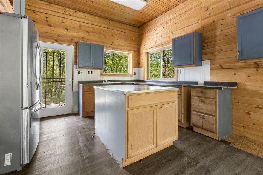 If you’re looking for a quiet private retreat deep in Newton County, over 4 miles down a dirt road, then look no further! The 1100 Sqft cabin features 1 big bedroom with covered deck access, and a walk in closet. 1 full bathroom, and an open living room, dining, and kitchen in the main area. There is an unfinished room that is attached with exterior entrance only, that is plumbed for gas heat. The 10.38 acres is the perfect mix of openness, and woods. With a garden area already set up, a concrete slab that is ready for you to build a shop or garage on, a strong built chicken coop, and an abundant amount of wildlife with a mix of Deer, Turkey & bear. The property also has a wet weather creek that has water 6-8 months of the year, as well as an old mining cave on the property. There is so much to love about this property, and an incredible opportunity to own a hunting cabin, homestead, or even your next primary residence. Lumber and wood building materials will convey with the property.