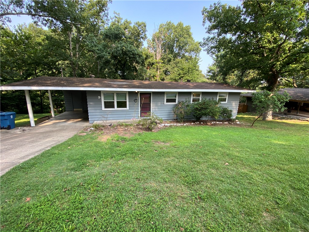 This charming 3 bedroom rental home has been freshly painted and has new windows, blinds and new carpet. There's an attached carport and a huge covered deck that overlooks a wooded area. Tenant will need to provide their own, fridge, washer, and dryer.
