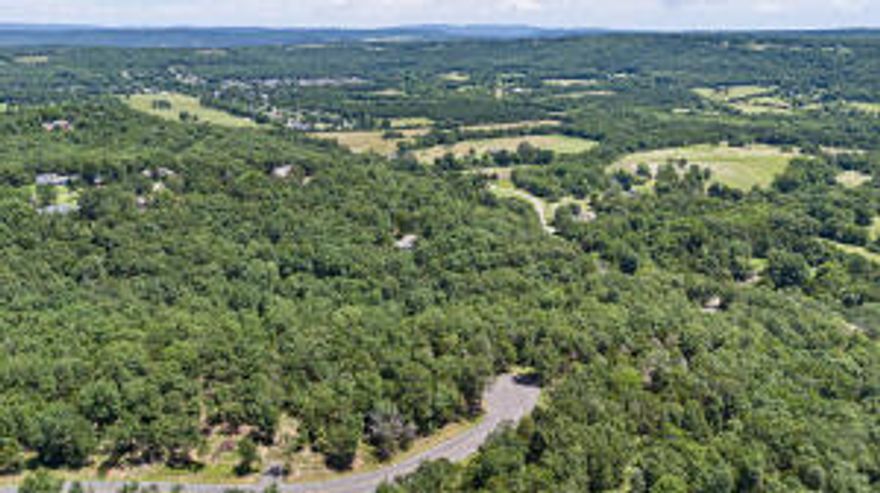 **Hot Price Adjustment** Discover the potential of this 2.29-acre wooded lot in a charming small town, offering future bluff views of the city and mountains once cleared. Situated on paved roads with utilities at hand, it's primed for your dream retreat. Unveil the beauty of the landscape as you carve out your sanctuary, where serene vistas await. Seize the opportunity to craft your ideal haven amidst nature's grandeur.