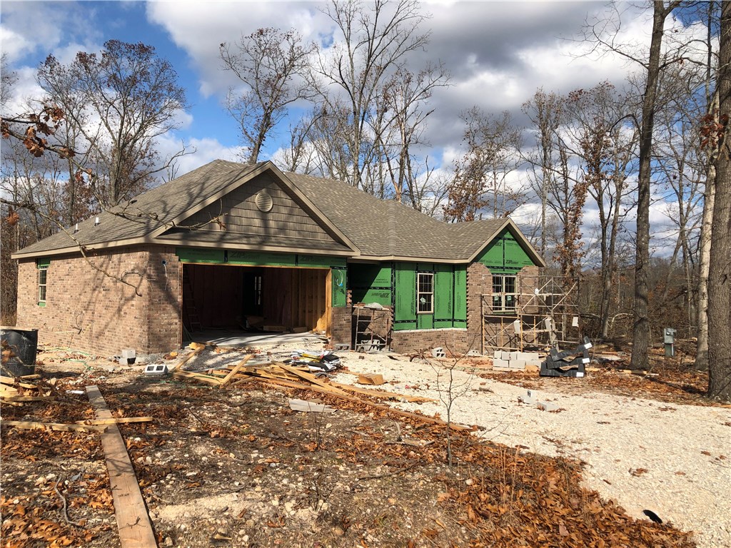 New construction on quiet street in the Highlands area of Bella Vista. Mostly level lot on all 4 sides, open split plan with kitchen island and corner fireplace, large covered deck, no other homes as of time of listing to the front, back or either side of this house. Master suite includes 2 walk-in closets, double vanity, step in shower plus soaking tub. Close to new bypass entrance and Highlands Links golf course/restaurant.