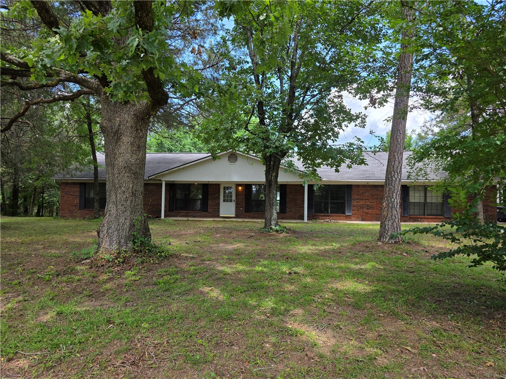 Hard to find 4 bedroom/2 bath brick home on Crow Mountain with 2.73 acres. It is a double lot. Deer feed out back. Enjoy the wood burning fireplace during fall and winter and the back deck and covered front porch during spring and summer. The kitchen offers bar seating and there is a separate dining room. Both are open to the living room. Refrigerator, washer, and dryer convey. There are also 2 outbuildings that convey.
