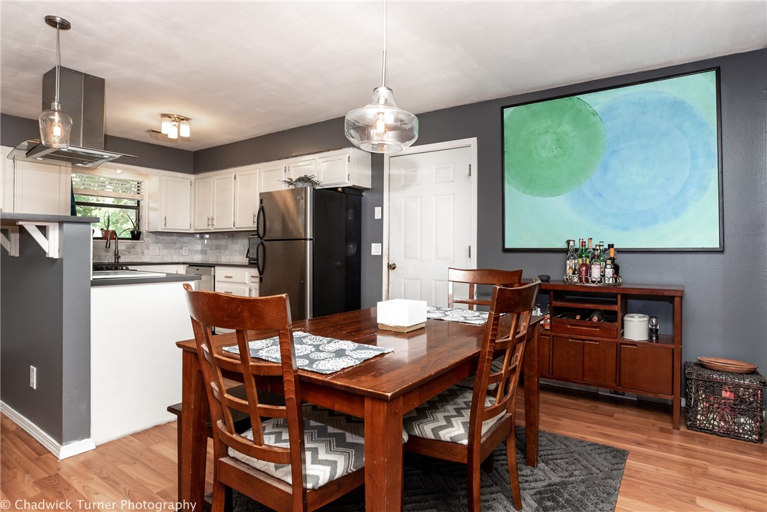 Live Downtown without paying for it! Priced under the market for a quick sale! Updated, open kitchen w/ stainless appliances, gas cooking and quartz counters, all wood laminated floors. Shady backyard with mature trees. Walk to 2 Elem schools & Lincoln Jr High. Bike to the square, close to trail system.